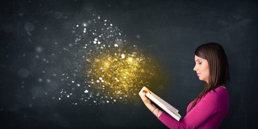 Young lady reading a magical book