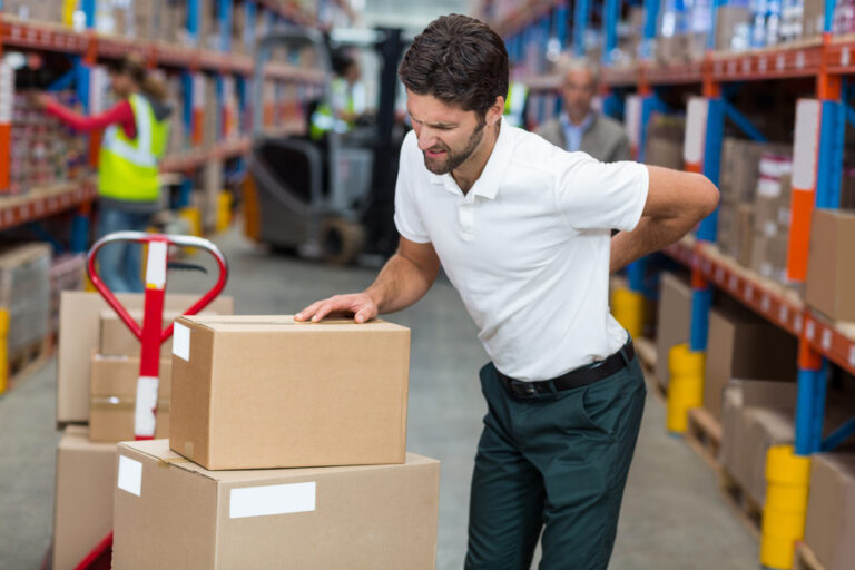 Male worker suffering from back pain while working