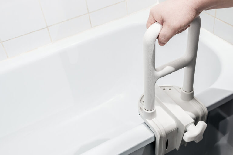 hand holding the handrail in the bathroom