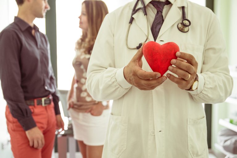medical concept about cardiology. doctor holding a plastic icon heart