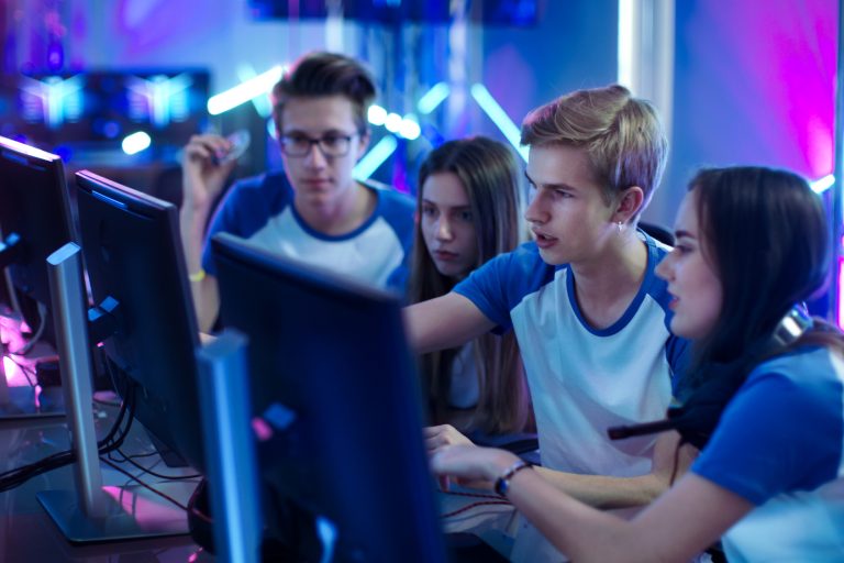 Team of Professional Boys and Girls Gamers Actively Thinking/ Di