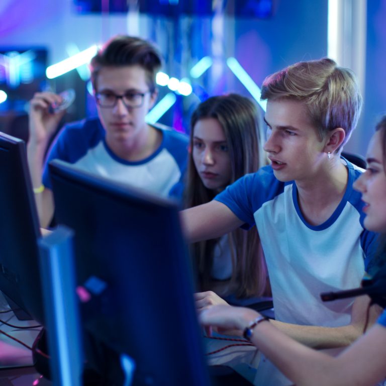 Team of Professional Boys and Girls Gamers Actively Thinking/ Di